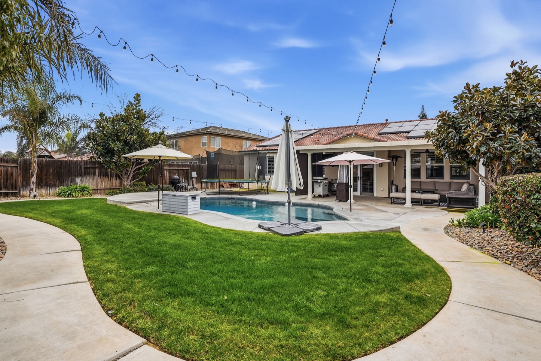 Backyard with lawn, pool and entertaining space