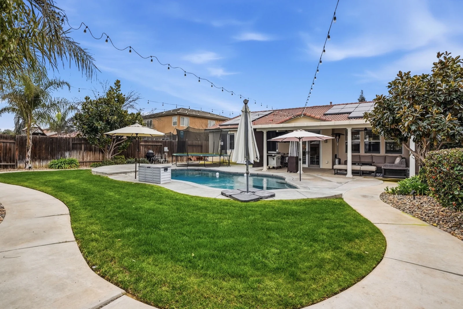 Backyard with lawn, pool and entertaining space