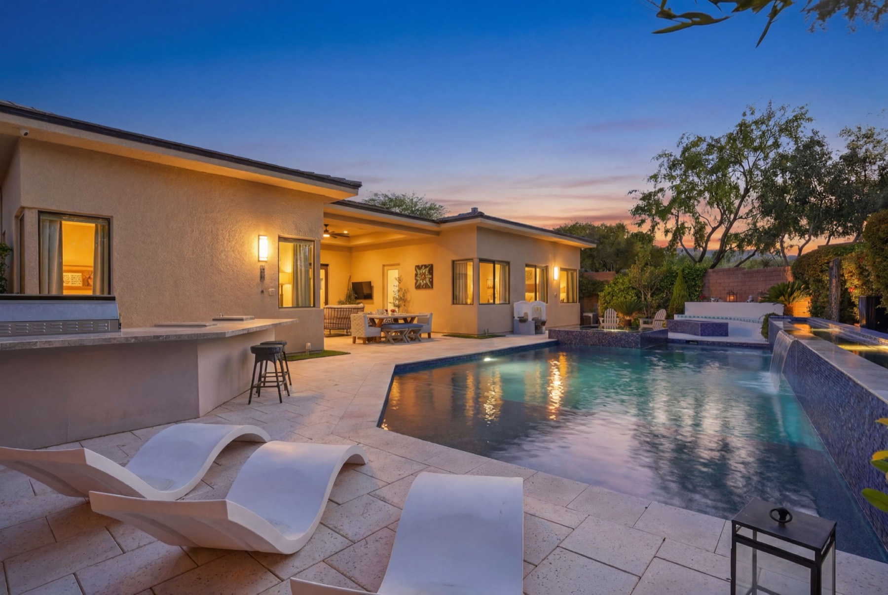 Pool and patio photographed at twilight